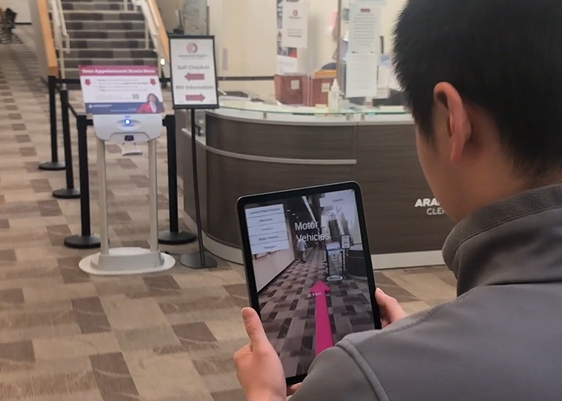 image of a man using an ipad to navigate