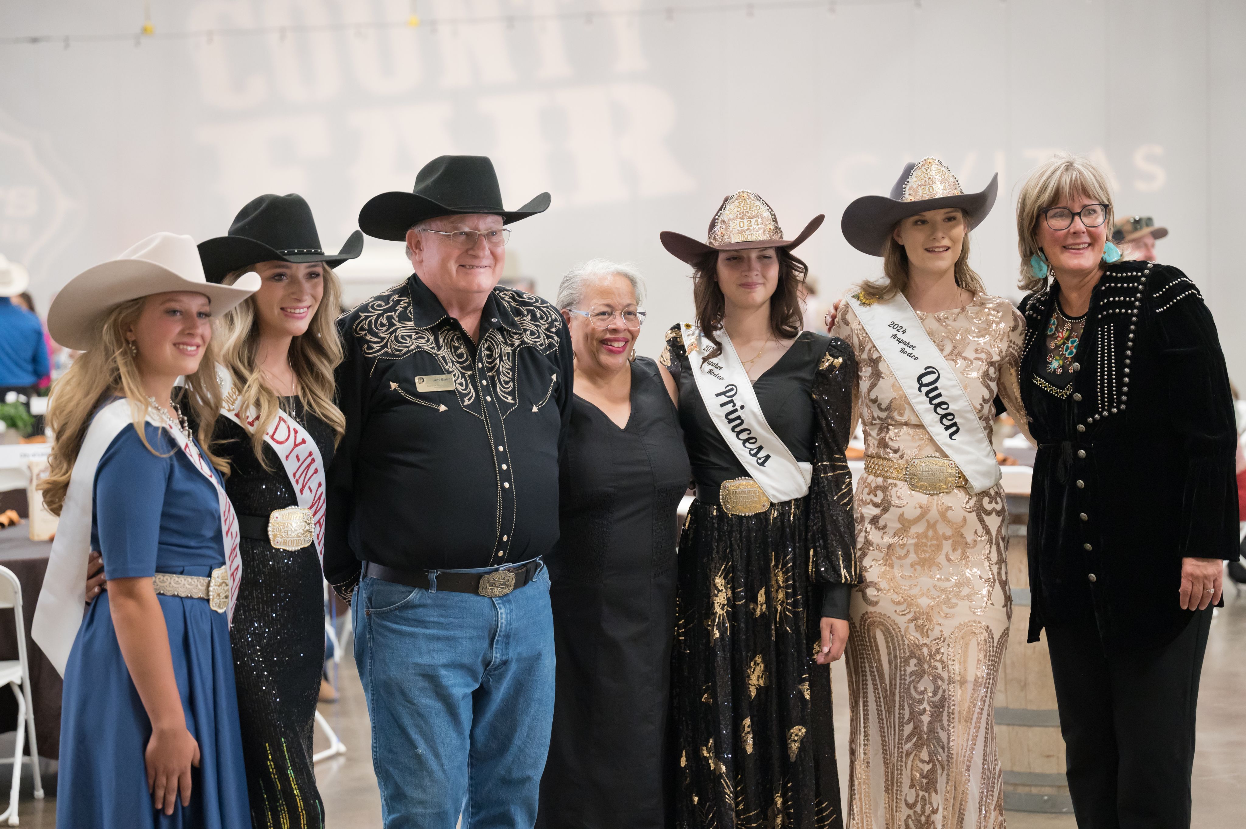 image of Commissioners and rodeo royalty at the Fair kick off dinner